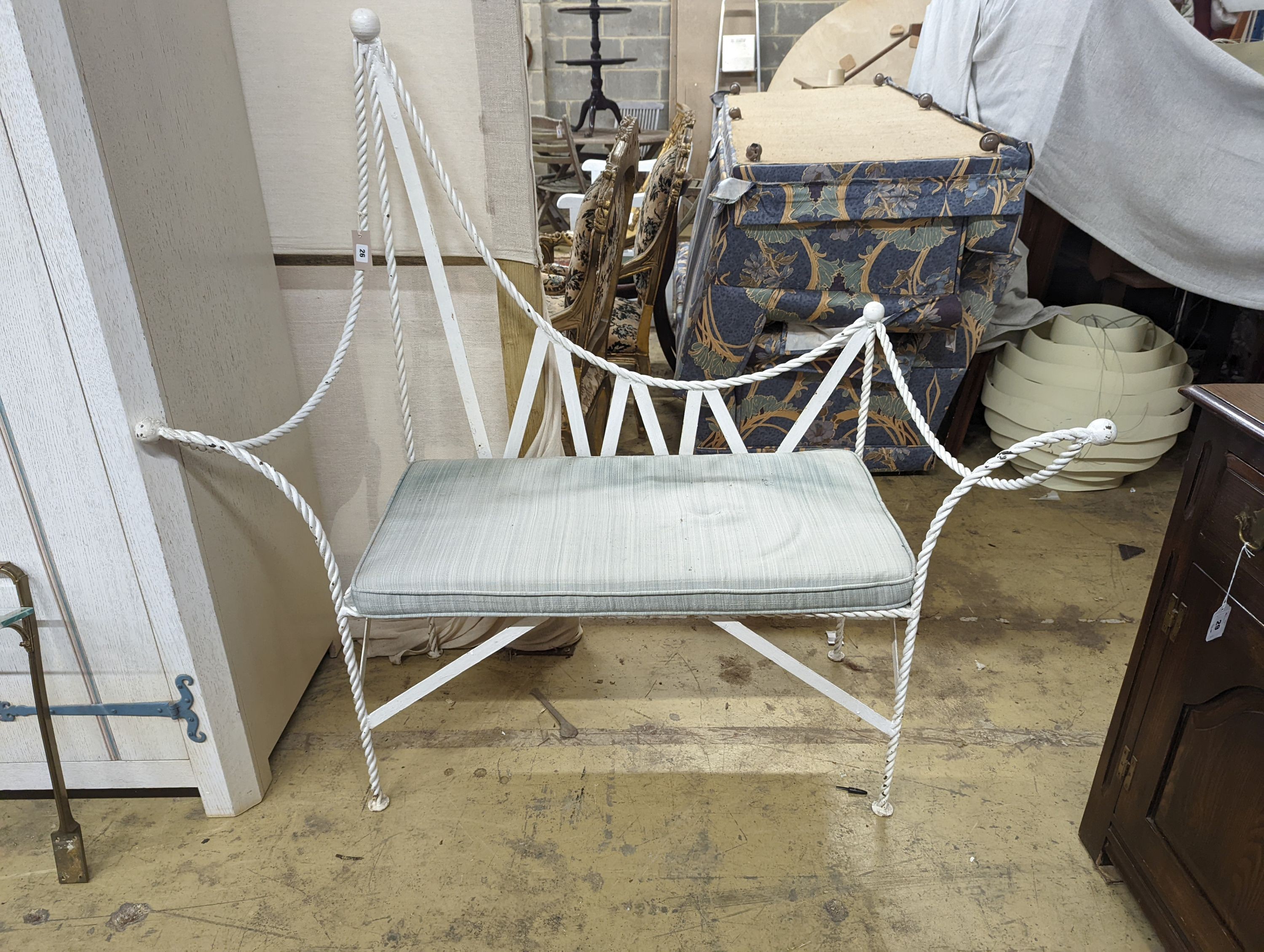 A wrought iron 'rope twist' seat with squab cushion, length 140cm, depth 54cm, height 132cm